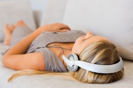 Woman Lying Down Listening to Headphones