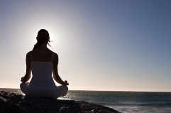 Woman Meditating on Beach